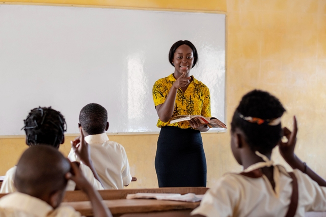 primary school student in a classroom and a female teacher